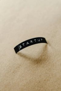 Close-up of a black label with 'STARTUP' text on a beige background, perfect for conceptual business themes.